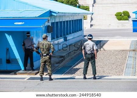 PANMUNJOM, SOUTH KOREA - MAY 9, 2014: Korean soldiers watching border between South and North Korea in the Joint Security Area (DMZ) on May 9, 2014 in Panmunjom, South Korea.