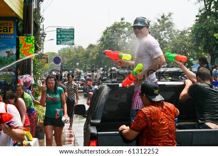 CHIANG MAI, THAILAND - APRIL 13: Tourist shoots from his water gun on April 13, 2010 in Chiang Mai, Thailand. Celebration of Thai New Year (Songkran water festival)  in 2010.