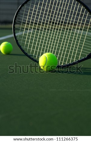 Tennis Balls and Racket on the Court with room for copy