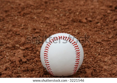 Baseball on red infield dirt
