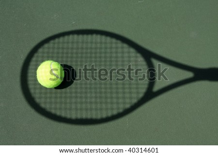 Shadow of a tennis racket and a ball