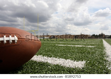 American Football on the Field with Goal posts beyond