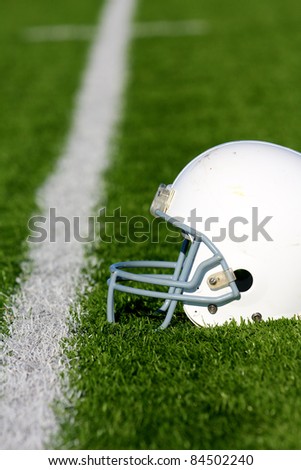 American Football Helmet on the Field with shalow depth of field and room for copy