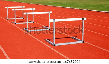 running tracks with three hurdles set up for training