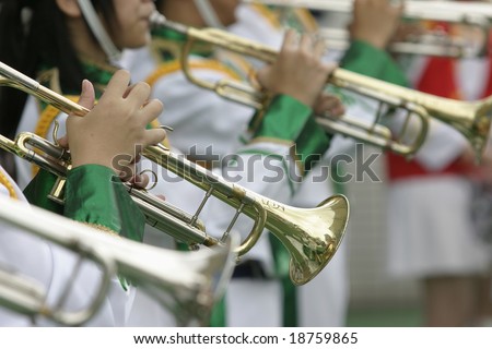 Close up of musicians playing trumpet in music band.