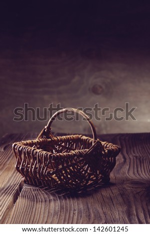 wooden empty basket over an aged table and wood background