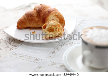 happy breakfast with brioches croissant and italian cappuccino with milch and coffee
