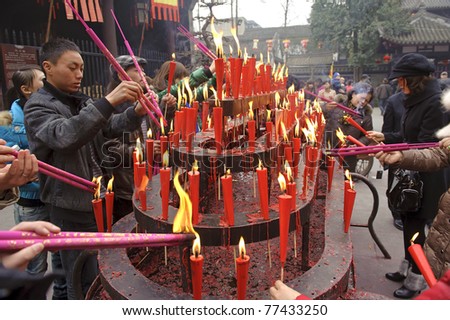 CHENGDU, CHINA  - FEB 5: People burn incense upon the incense altar in temple during Chinese New Year on Feb 5, 2011 in Chengdu, China. It is Chinese traditional custom.