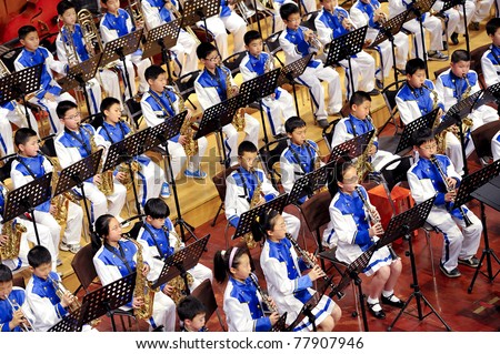 CHENGDU, CHINA - APR 23: Student symphonic band of High School No.7 Chengdu perform a concert on April 23, 2011 in Chengdu,China.