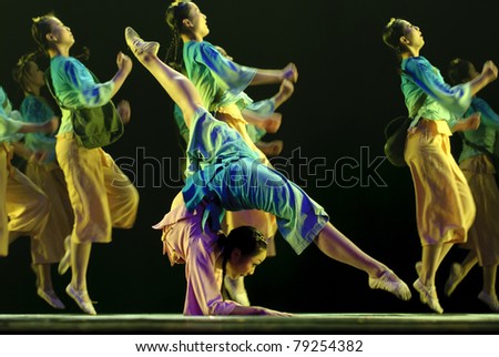 CHENGDU - DEC 10:Chinese dancers perform folk dance onstage at JINCHENG theater in the 7th national dance competition of china on Dec 10,2007 in Chengdu, China. Choreographer: Fei Bo, actor: 24