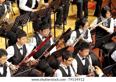 CHENGDU - APR 23: student symphonic band of High School No.7 Chengdu perform on concert on Apr 23,2011 in Chengdu,China.