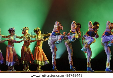 CHENGDU - DEC 15: Chinese ethnic dancers perform group dance on stage at JINCHENG theater in the 7th national dance competition of china on Dec 15,2007 in Chengdu, China.