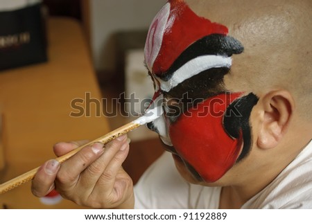 CHENGDU, CHINA - JULY 26: An unidentified Chinese opera actor is painting his face backstage at JinJiang theater on July 26, 2007 in Chengdu, China.