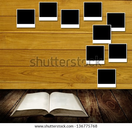 Reading book with photo frames post on wooden wall, Reading table concept