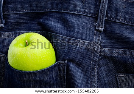 Green apple in Jeans pocket