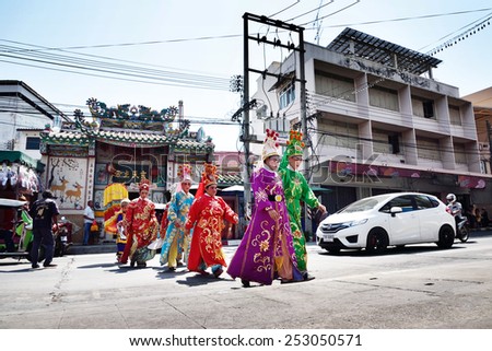 SRIRACHA, THAILAND -  FEBRUARY 5 : Chinese opera actors walking across the street to offering Shrine of the Black Sea on February 5, 2015 in  Sriracha, Chonburi, Thailand