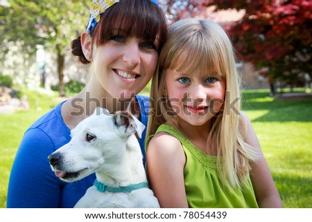 Portrait of mom and daughter with the family dog