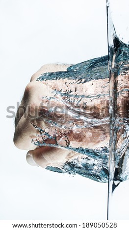 Isolated close up of a mans fist being punched through water