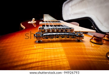 Wide Angle Shot of a Sunburst Electric Guitar Laying in a Hard Shell Electric Guitar Case