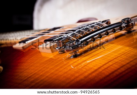 Close up Shot of a Sunburst Electric Guitar Laying In a Hard Shell Electric Guitar Case