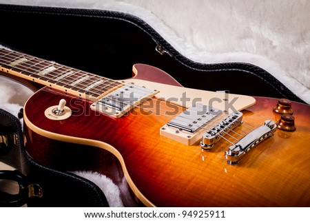 Beautiful Sunburst Electric Guitar Laying in a Hard Shell Electric Guitar Case