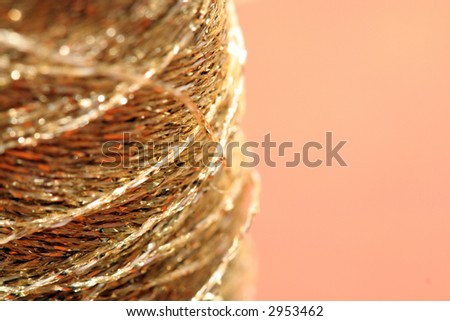 golden sewing line with salmon background