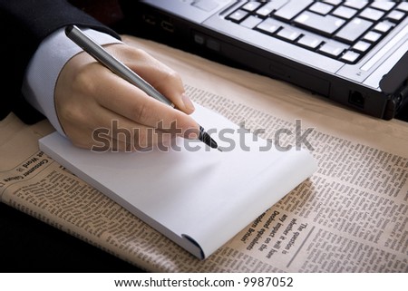 businesswoman in office with notebook laptop and newspaper