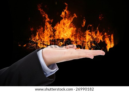 businesswoman hand holding fire flames - business concept