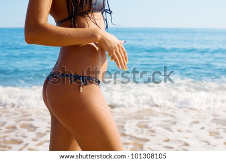 Slim figure of a young woman against the sea