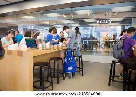 HONG KONG, CHINA - JUNE 15, 2014: Buyers and shop consultants at Apple store in Hong Kong. Store is in a shopping center IFC Mall, it is very popular with locals and tourists visiting Hong Kong.