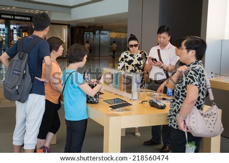 HONG KONG, CHINA - JUNE 18, 2014: Shoppers in Apple store in Hong Kong. Store is in a shopping center IFC Mall, it is very popular with locals and tourists visiting Hong Kong.