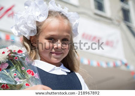 First grader girl in the first day of training at the school. Russia.