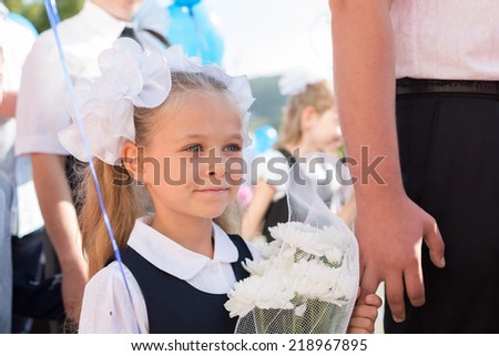First grader girl in the first day of training at the school. Russia.