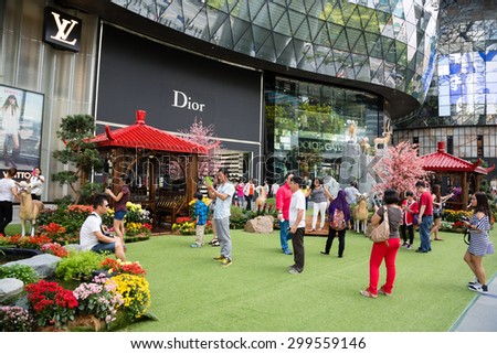 SINGAPORE - CIRCA FEBRUARY, 2015: People relax in the entertainment area at the mall ION Orchard - one the best shopping centers on Orchard Road. In the mall more than 300 shops of the famous brands.