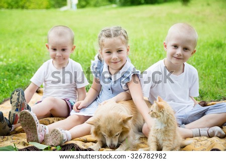 Sister with brothers with a cat and a dog in the park