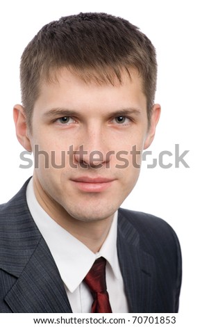 Portrait of a handsome young businessman with a slight smile on his face.
