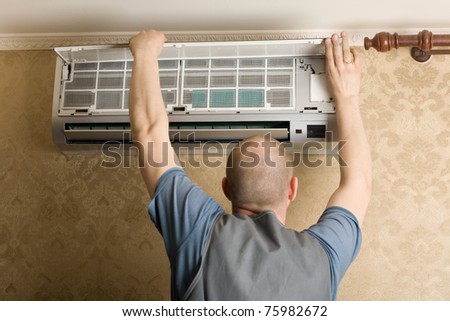 Adjuster air conditioning system sets a new air conditioner in the apartment.
