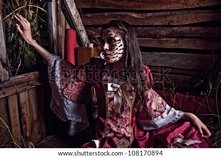 Fine art photo of a young fashion lady in a dark mystic location.