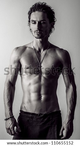 Beautiful and health athletic caucasian muscular young man. Black-white photo.