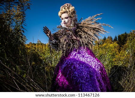 Dramatized image of sensual girl symbolizing autumn. Art Fashion outdoor photo.