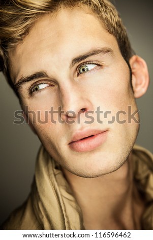 Closeup portrait of sensual man with beautiful face and eyes.