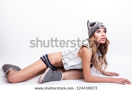 Young sensual model woman on cat hat pose in studio.