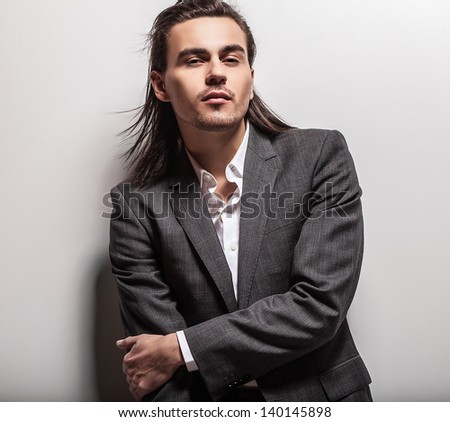 Elegant young handsome long-haired man. Studio fashion portrait. Elegant young handsome long-haired man. Studio fashion portrait.