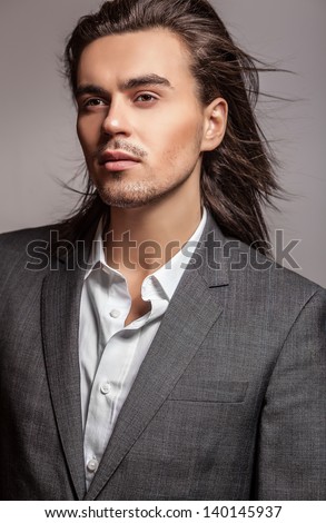 Elegant young handsome long-haired man. Studio fashion portrait. Elegant young handsome long-haired man. Studio fashion portrait.
