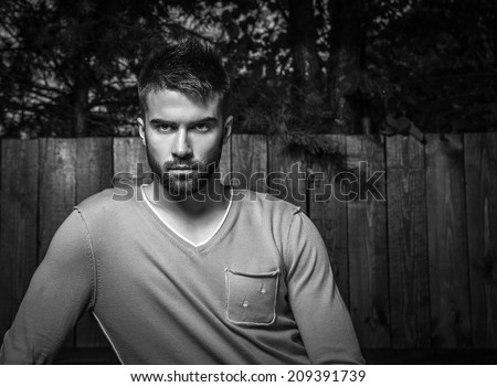 Portrait of young beautiful man, against outdoor background.
