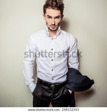 Elegant young handsome man in white shirt. Studio fashion portrait.