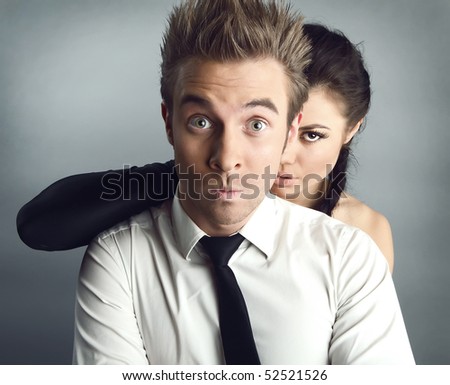 Surprised charming couple embrace each other. Beautiful and happy. Studio photo with copyspace.