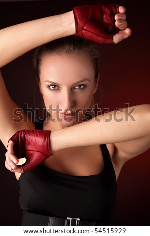 Attractive posing blonde in a red sport gloves. Fashion photo.