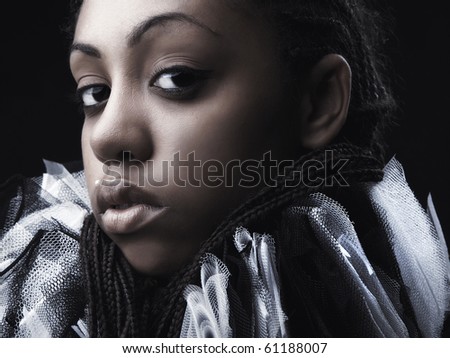 Attractive afro-american beauty in a black-white theatrical jabot. Close-up Portrait.