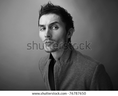 Young man's face. Close-up portrait. Black-white photo.